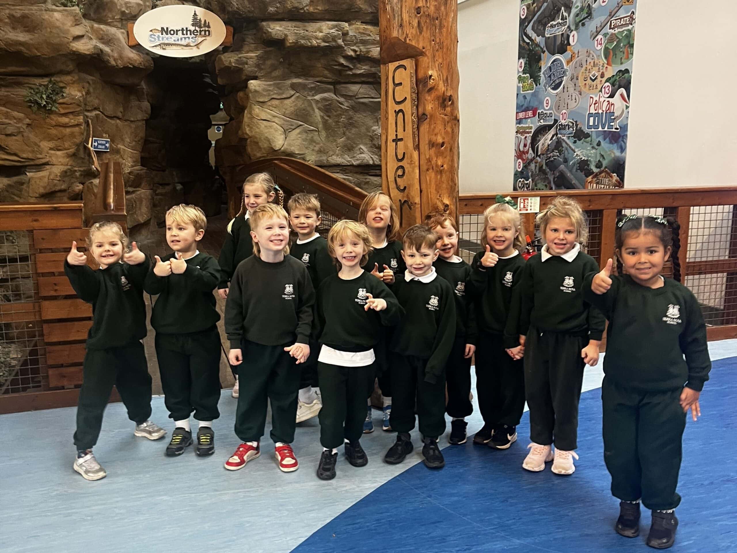 Group of happy children at an aquarium