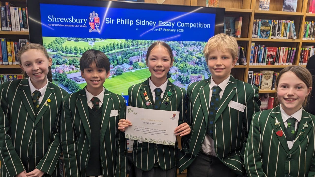Children smiling holding up certificates