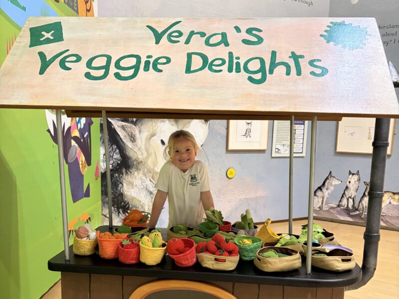 Young girl at vegetable stand
